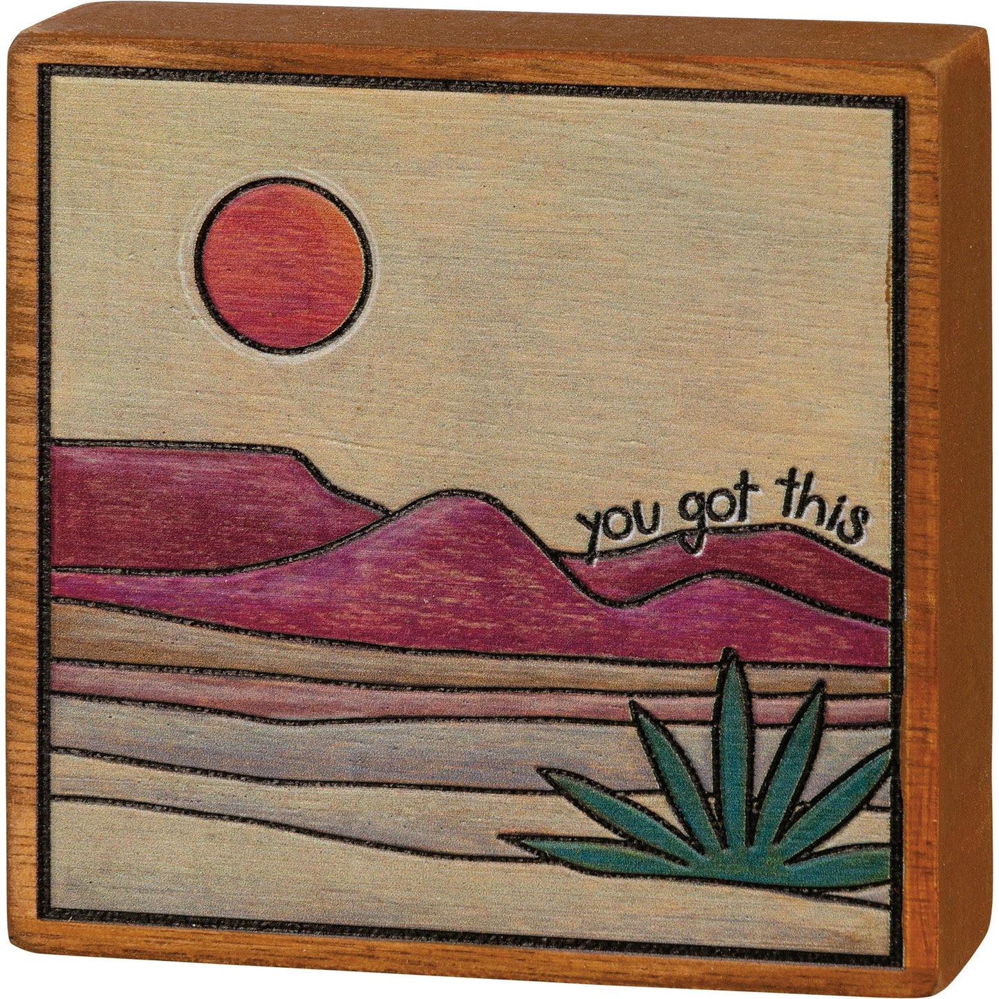 Frame on burnt wood block, desert image.