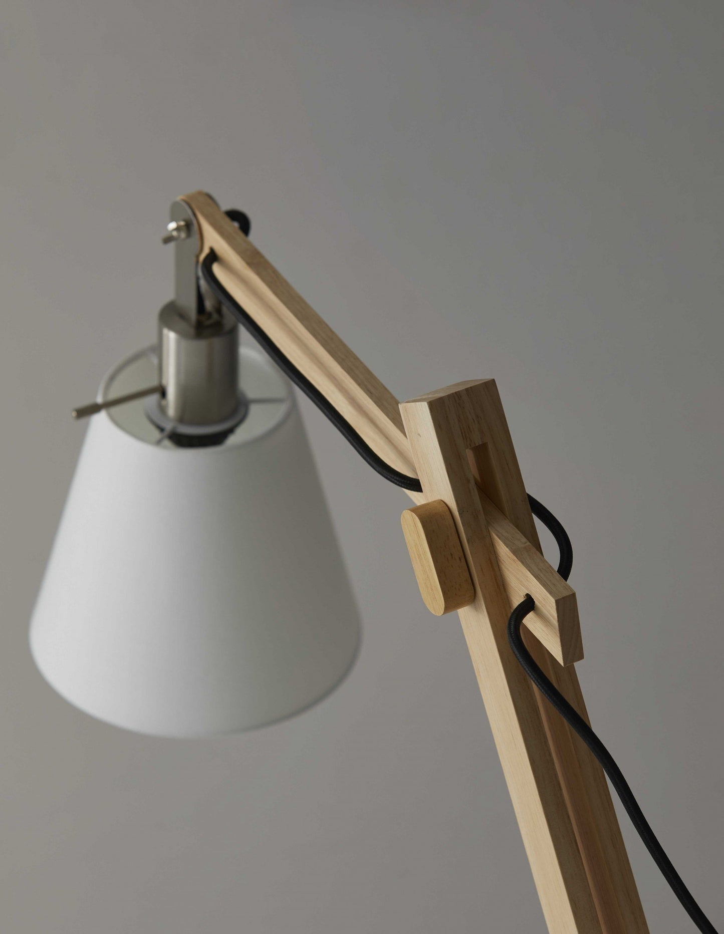 Natural wood table lamp with rustic hinges.