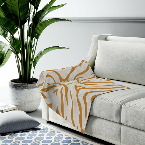 Beige throw with mustard tiger patterns