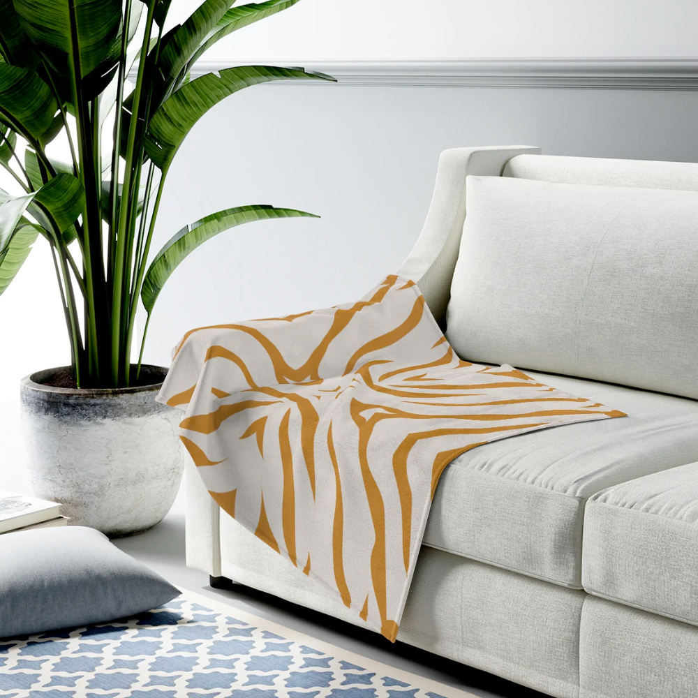 Beige throw with mustard tiger patterns